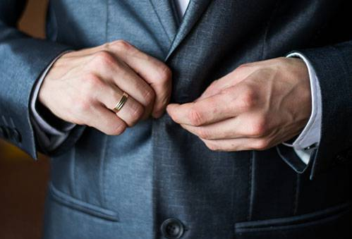 Чоловік застібає піджак